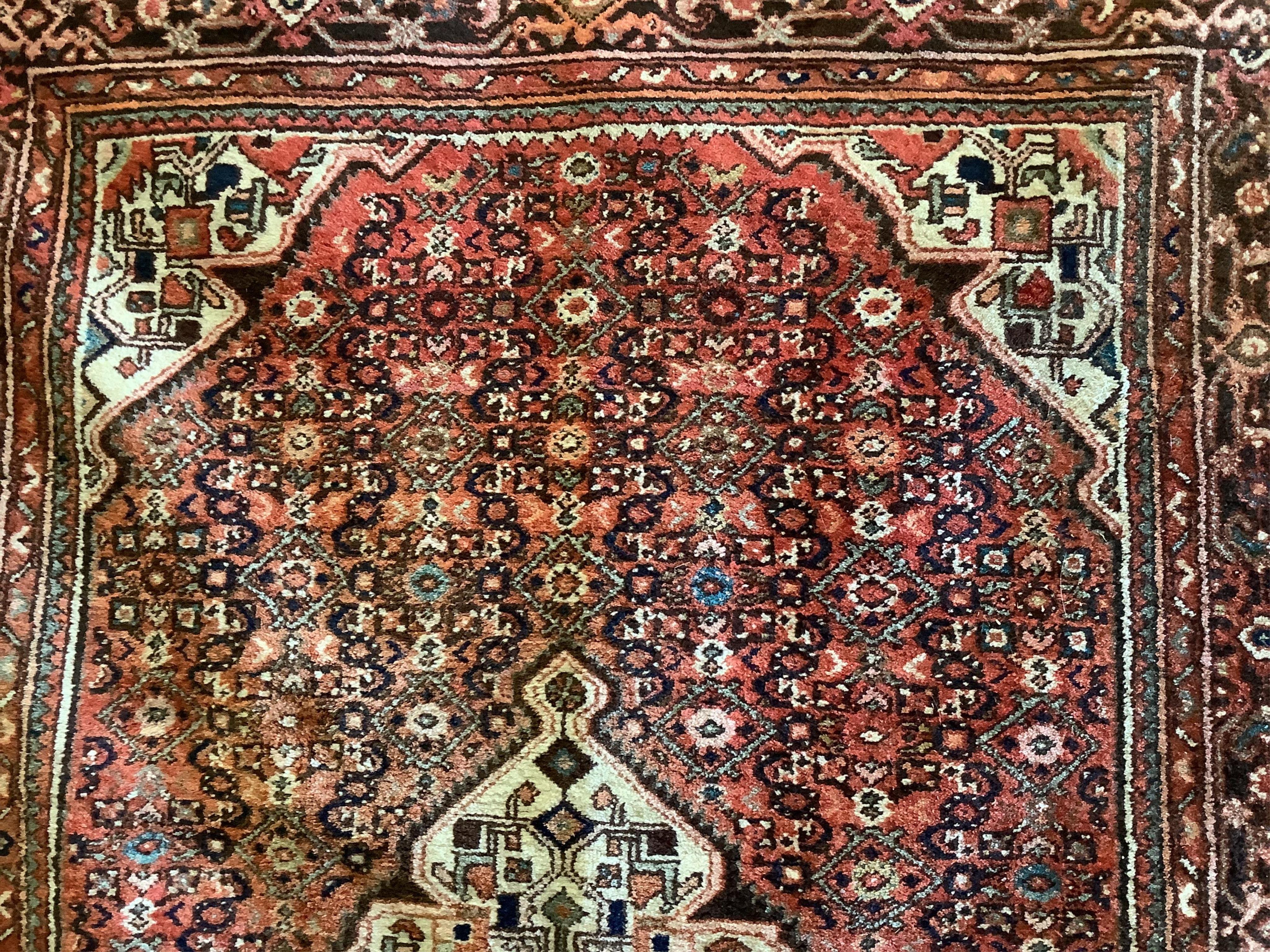 A Hamadan red ground rug, approx. 220 x 160cm. Condition - fair